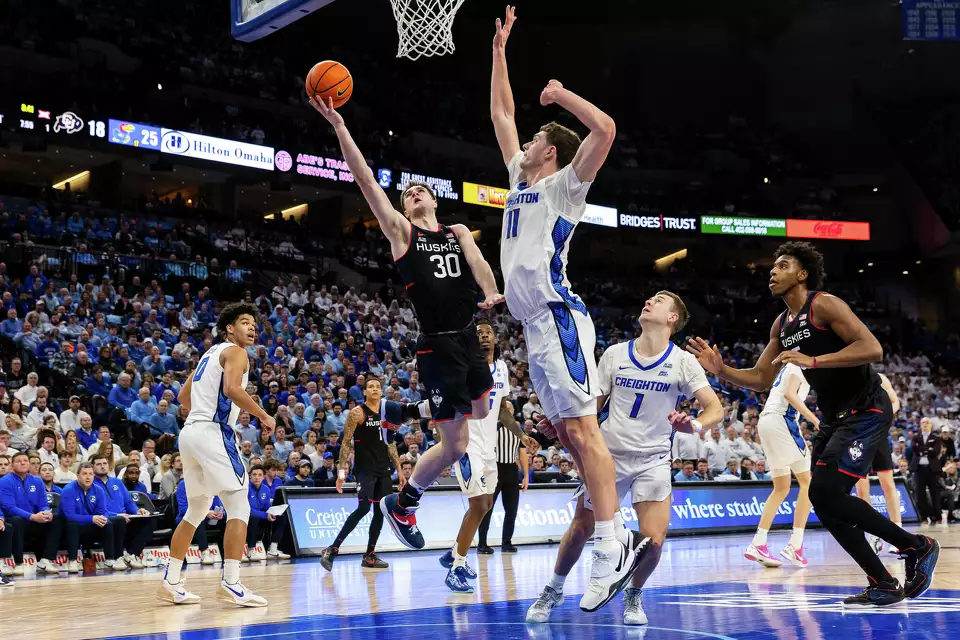 2/11/25 Omaha, NE Chi Health Center Omaha|UConn forward Liam McNeeley (30) goes up for a layup against Creighton center Ryan Kalkbrenner (11) during the first half of an NCAA college basketball game. Mandatory Credit: (AP Photo/Bonnie Ryan)