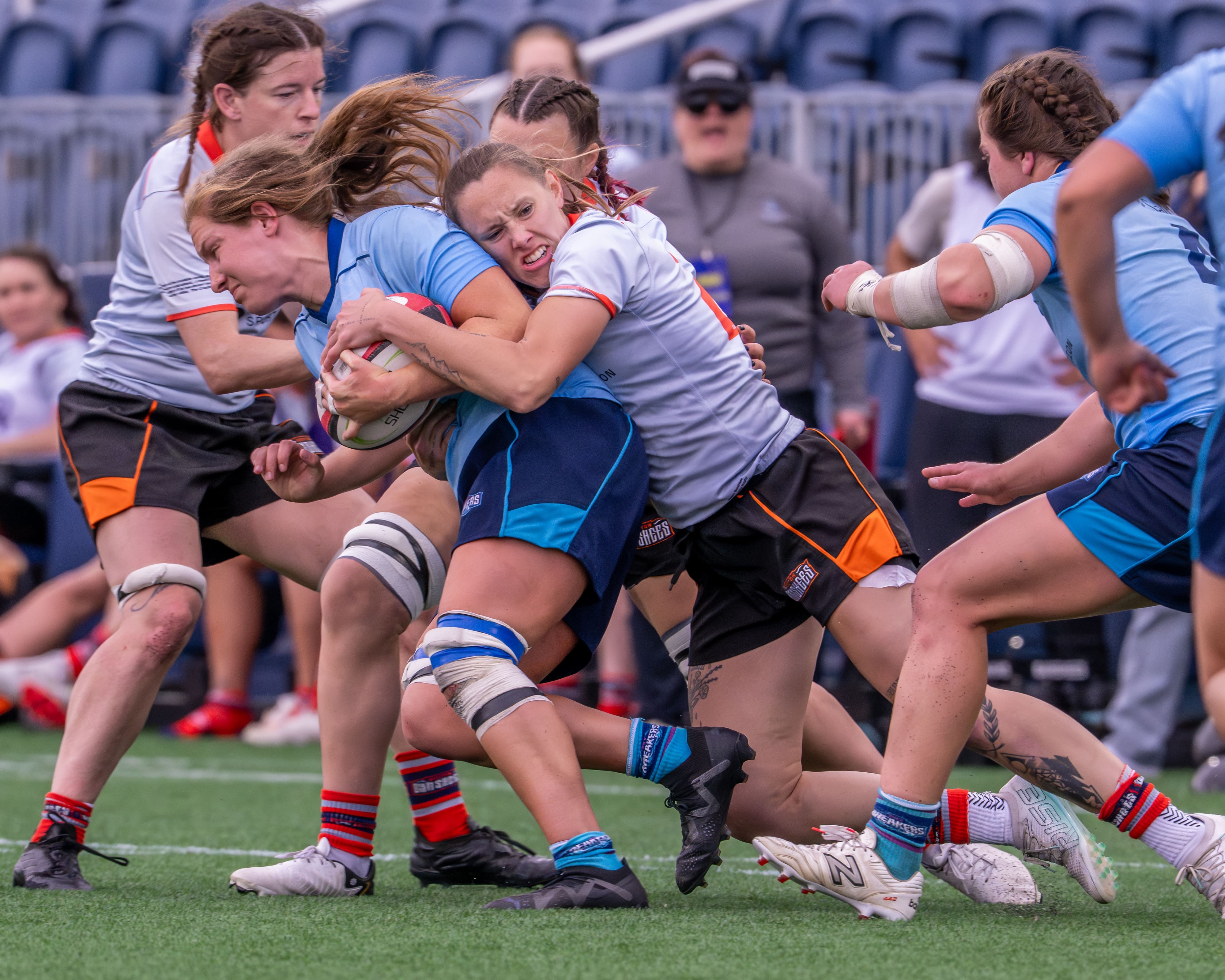 Katie Lohaus tackles a Breakers player. Photo by Greg Sabin via gregsabinphotography.com.