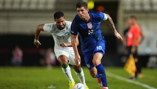 Christian Pulisic (#10) dribbles past Saudi Arabia midfielder during USMNT vs Saudi Arabia international friendly match