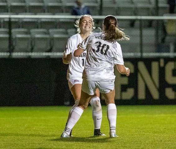 Army West Point's Bella Conti celebrates with goal scorer Brigid Duffy after Duffy's goal against Loyola at Clinton Field on October 24, 2025