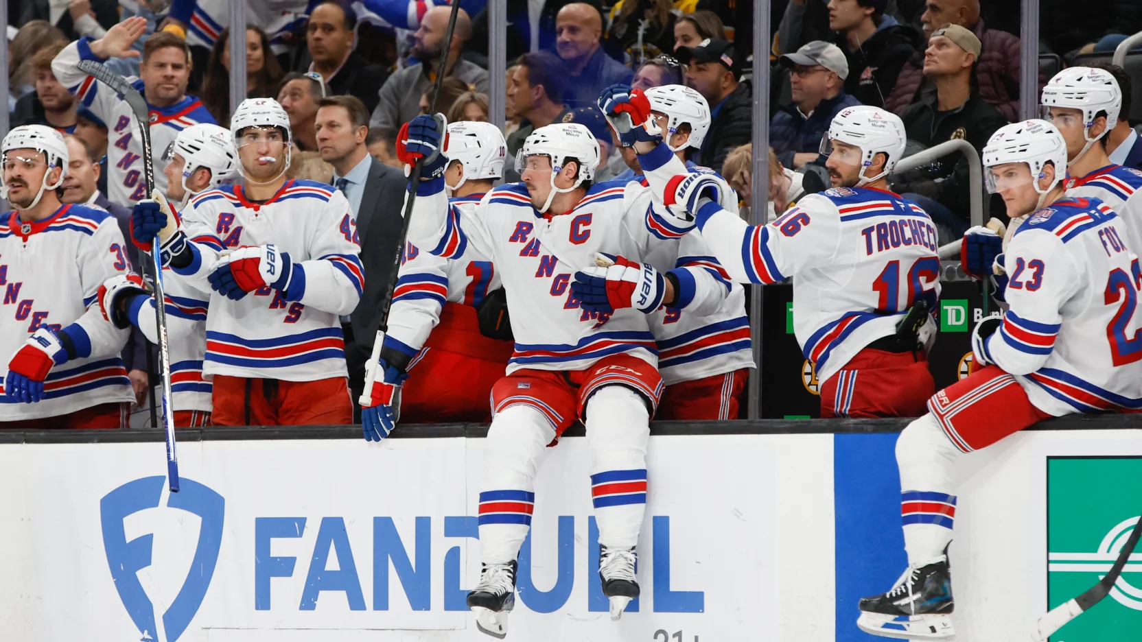 11/28/2025 TD Bank Gardens, Boston, MA., J.T. Miller Celebrates the win on the boards at the Bench. Mandatory Credit: New York Rangers