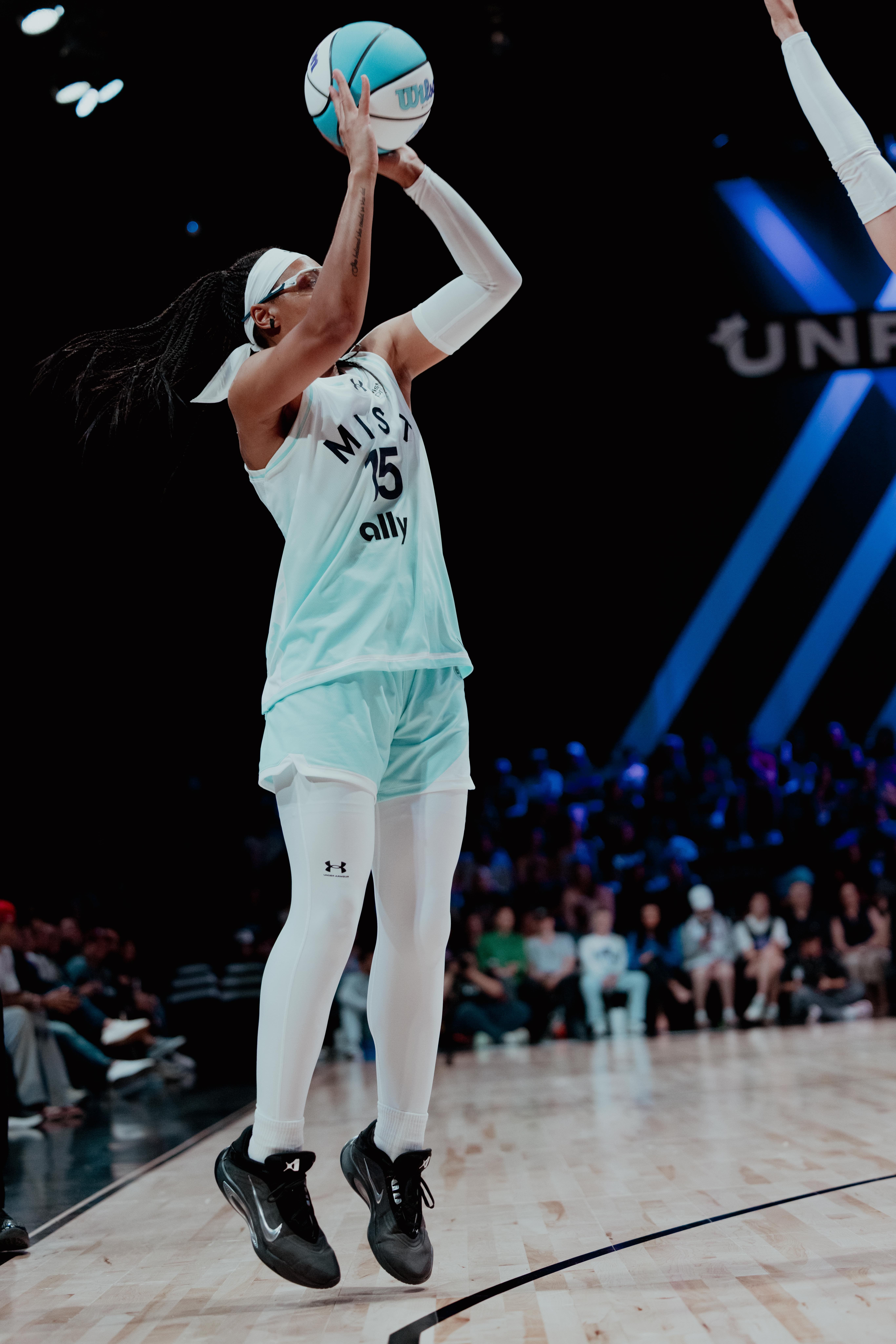 Allisha Gray (No. 15) of Mist BC hangs in the air while taking a jump shot during a game against Lunar Owls BC at Sephora Arena in Miami.