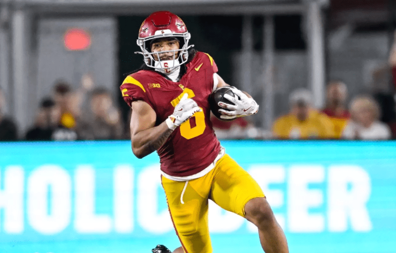 USC Trojans receiver Makai Lemon runs upfield with the ball after a catch during a game. Mandatory Credit: USC Trojans Athletics.