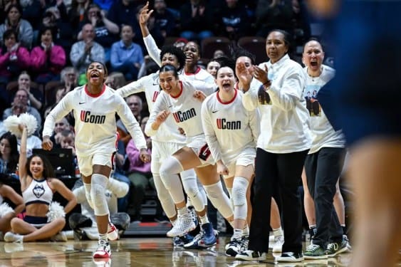 UConn players and staff erupt in celebration on the bench during the Big East quarterfinal against Georgetown at Mohegan Sun Arena. Mandatory Credit: Simon Asher/University of Connecticut Athletics.