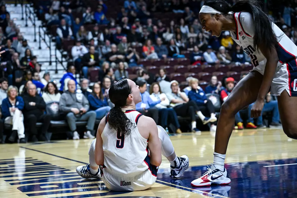 Kayleigh Heckel sits on the court as Serah Williams reacts with intensity during UConn’s Big East quarterfinal matchup against Georgetown at Mohegan Sun Arena. Mandatory Credit: Simon Asher/University of Connecticut Athletics.