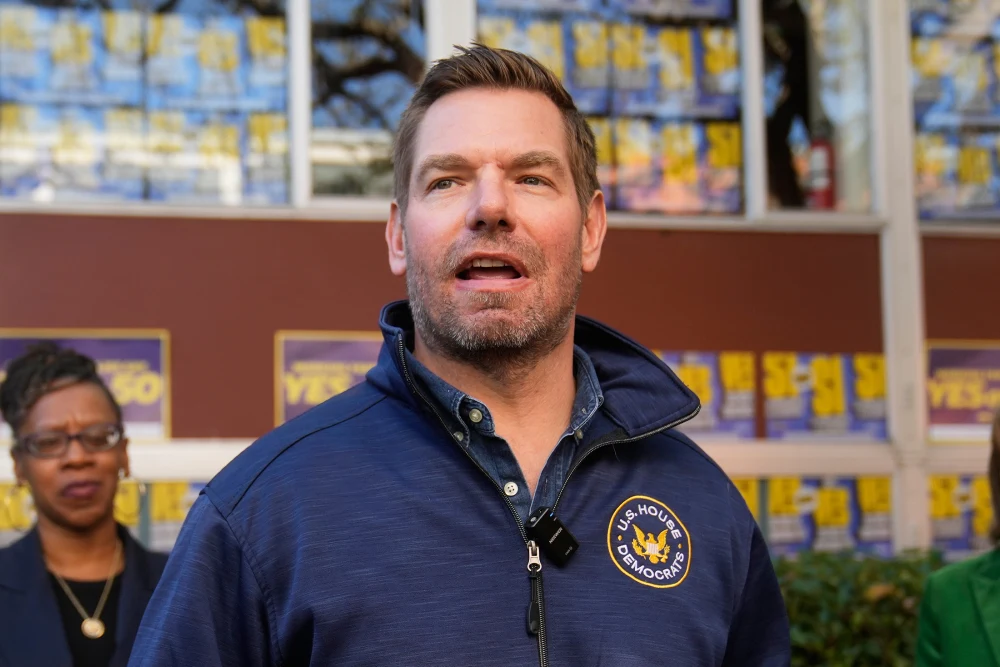 Rep. Eric Swalwell wearing a U.S. House committee pullover jacket during a congressional appearance.