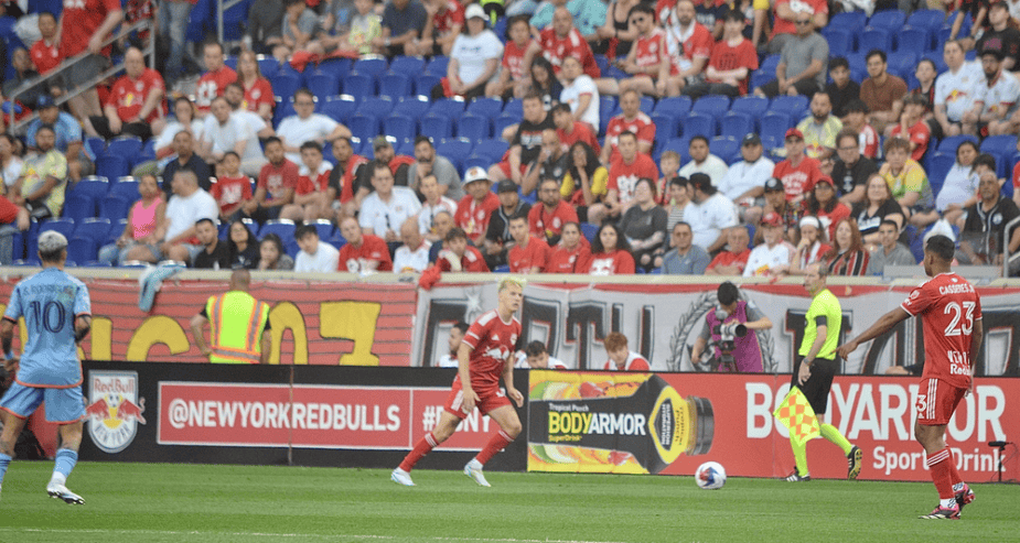 Photo Credit Soccer LI Magazine The New York Red Bulls playing the ball down the sideline, building their attack against New York City FC. Forward Tom Barlow of the Red Bulls and Midfielder Cristian Cásseres of the Red Bulls. Defending the play is City midfielder Santiago Rodriguez(10).