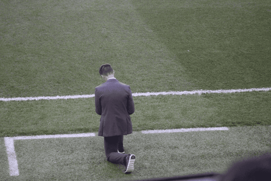 Photo Credit Bad Dawg Sports New York Red Bulls Head Coach Troy Lesessne takes a knee prior to the opening kickoff to pray before the match.