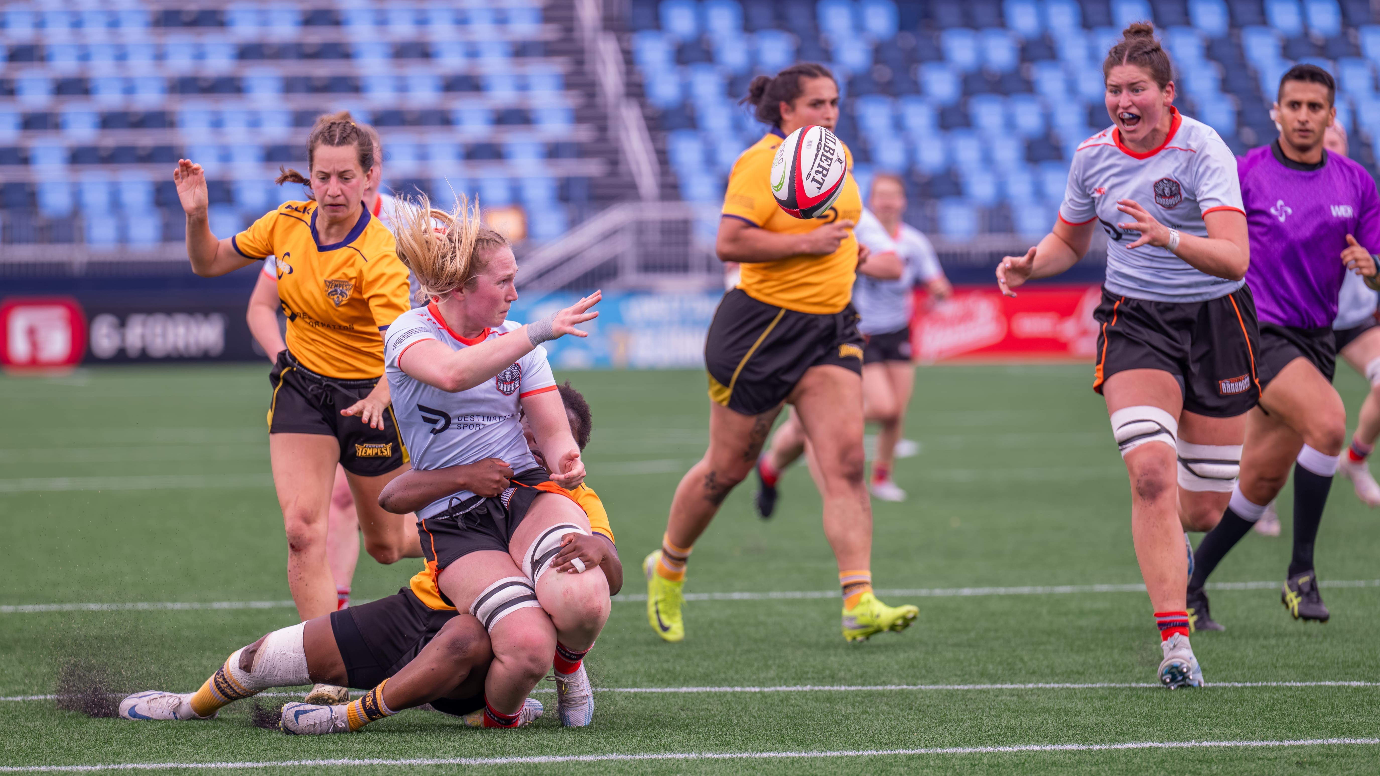 Banshees flanker Gen Quirion off-loads to captain Jenny Kronish. Photo by Greg Sabin of gregsabinphotography.com.