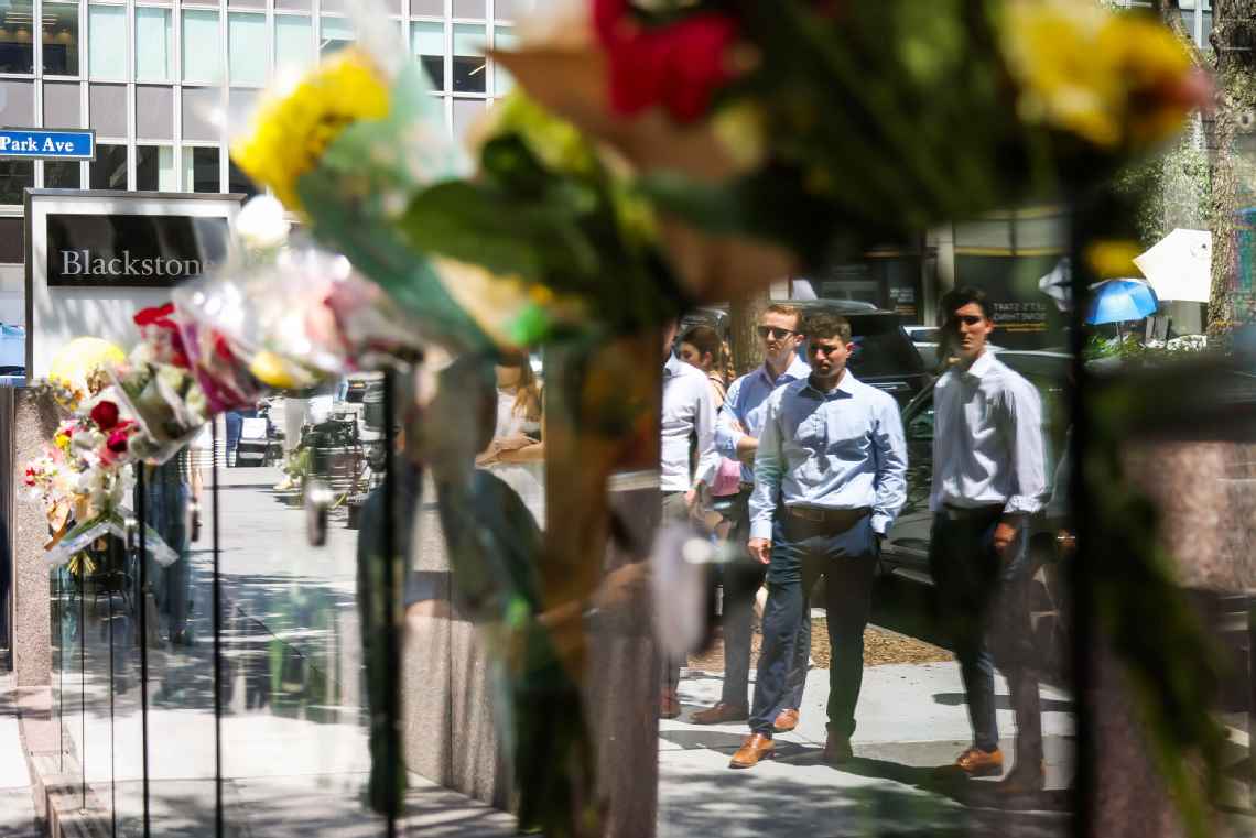 Mourners visit a memorial outside a midtown Manhattan building, scene of a July 28 fatal shooting. Michael Nagle/Bloomberg via Getty Images