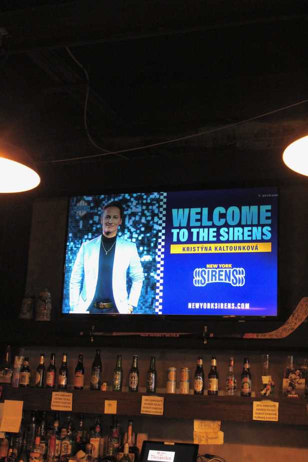 Television screen displaying "Welcome to the Sirens" graphic featuring Kristyna Kaltounkova