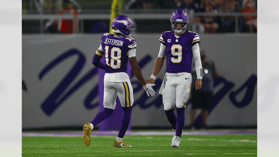 Minnesota Vikings wide receiver Justin Jefferson #18 gives a low five to quarterback J.J. McCarthy during the team's Week 2 Sunday Night Football game against the Atlanta Falcons at U.S. Bank Stadium