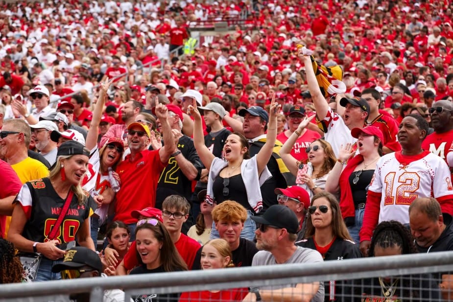 Maryland Terrapins fans celebrate enthusiastically in the stands during a historic 27-10 victory over the Wisconsin Badgers at Camp Randall Stadium in Madison, Wisconsin