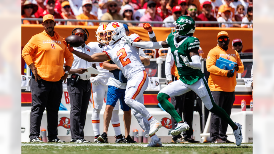 Tampa Bay Buccaneers rookie wide receiver Emeka Egbuka #17 making spectacular one-handed catch along sideline while New York Jets defender attempts coverage during 29-27 Bucs comeback victory