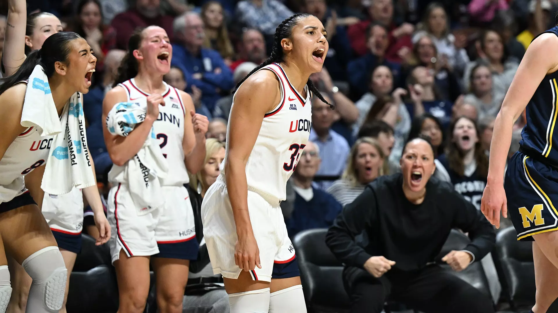 UConn Huskies women's basketball players celebrate enthusiastically from the bench during game against Michigan at Mohegan Sun Arena, November 21, 2025