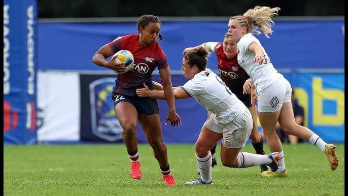 USA Women’s Rugby Sevens ball carrier breaks a tackle as Great Britain defenders close in during an SVNS match in Cape Town, South Africa.