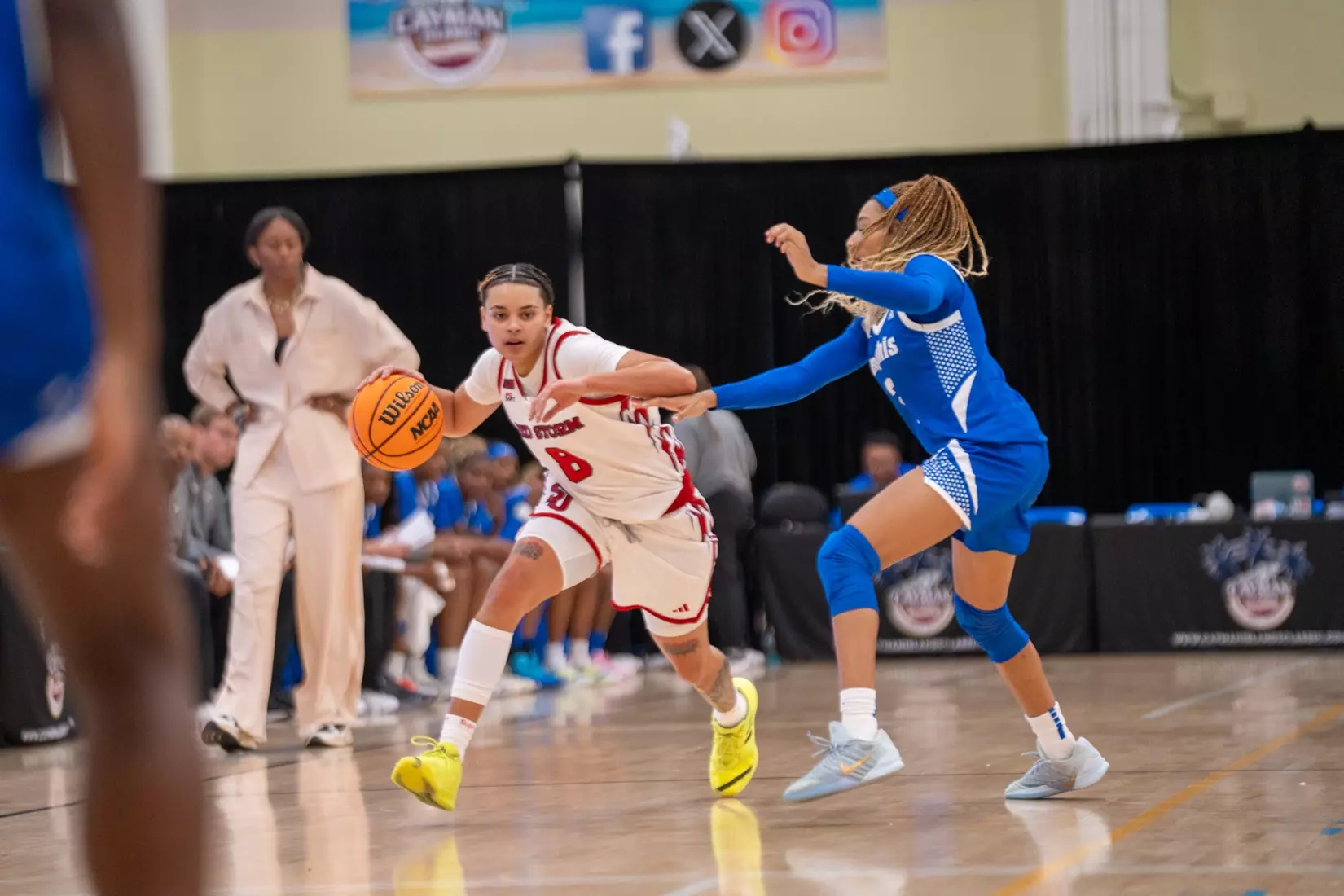 St. John's graduate guard Shaulana Wagner, number 8, drives to the basket against the Memphis Tigers’ defense during the 2025 Cayman Islands Classic championship game at John Gray Gymnasium in George Town, Grand Cayman