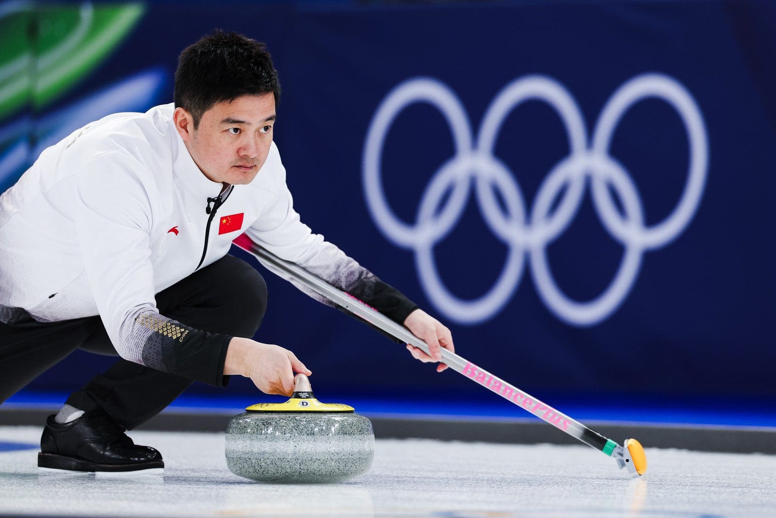 Photography by Celine Stucki of World Curling as Daniel Casper throws the hammer down.