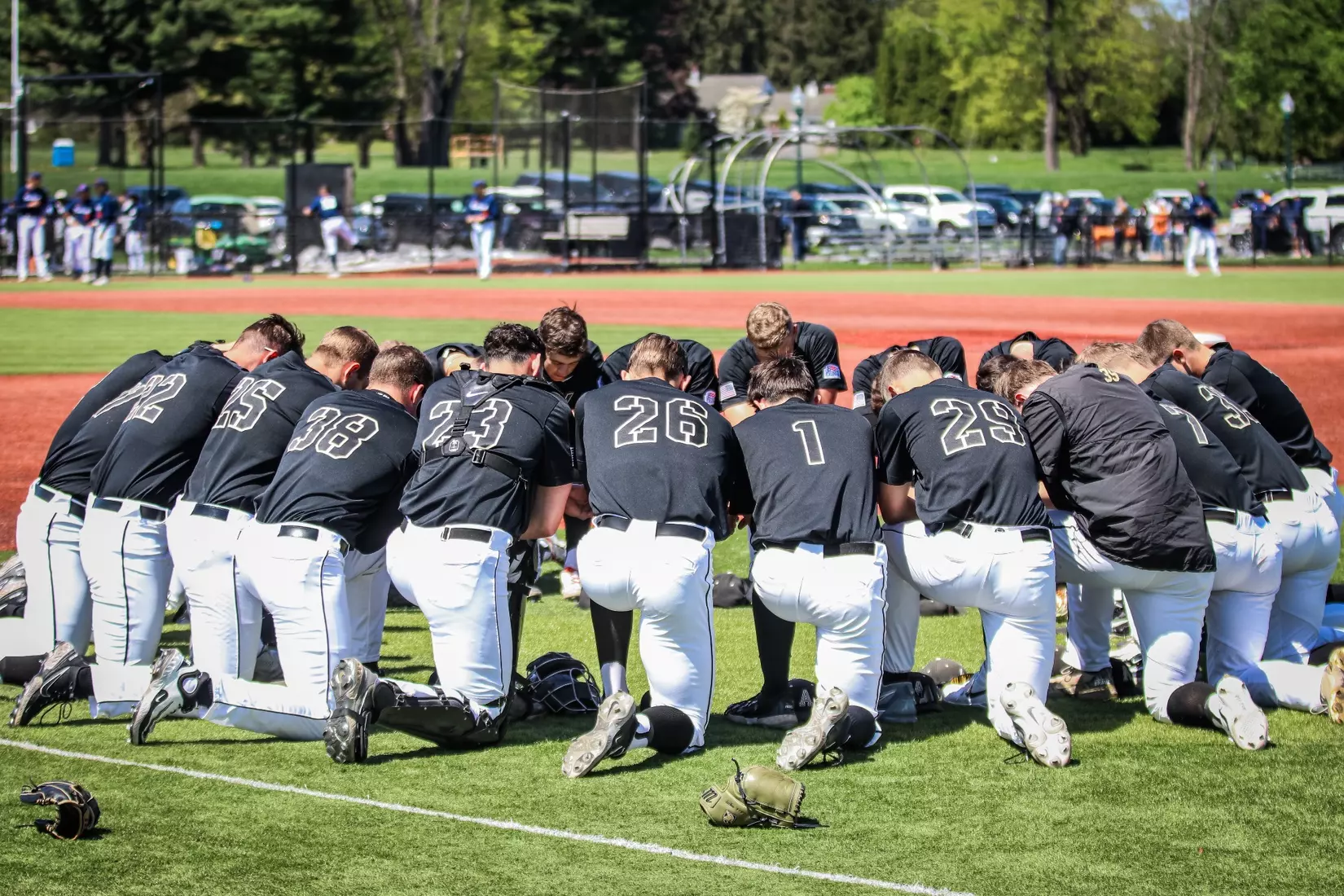 Army West Point baseball players huddle on the field before a doubleheader against No. 19 Clemson.