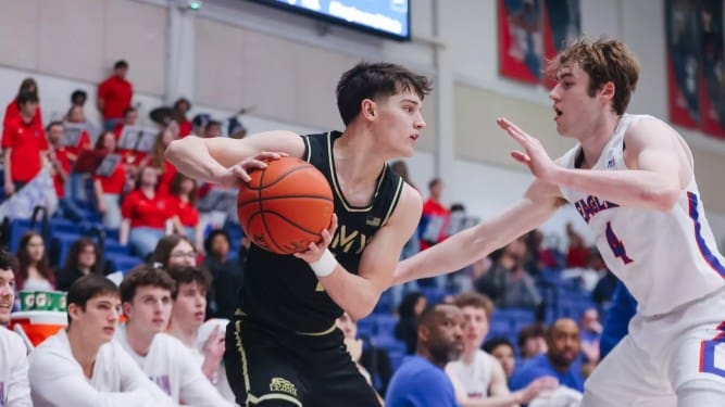 Army Black Knights freshman guard Jackson Furman cradles the ball and scans for passing options as a defender closes in.