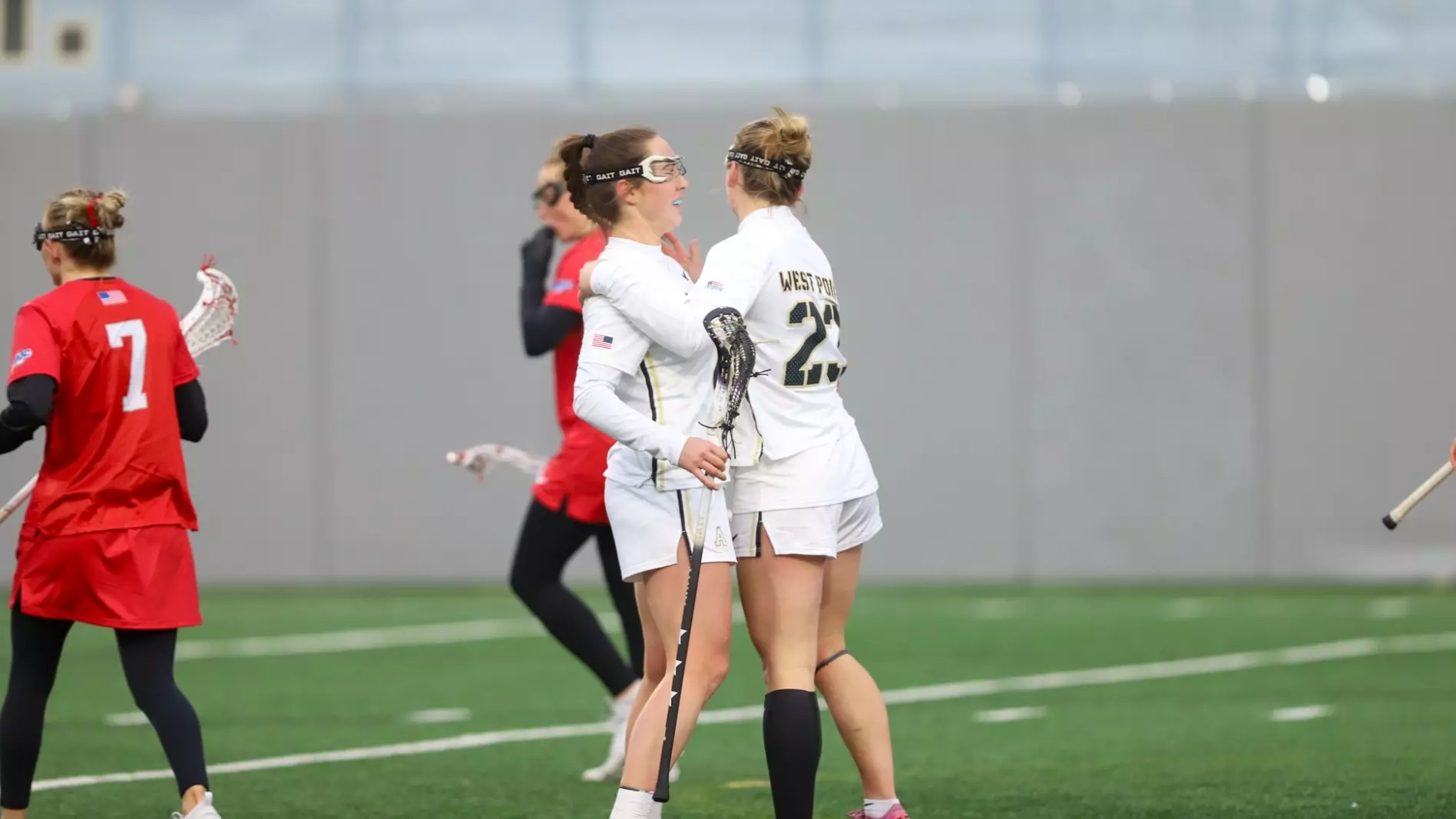 Army West Point seniors Brigid Duffy and Allison Reilly celebrate together on the field during a Black Knights women’s lacrosse game.