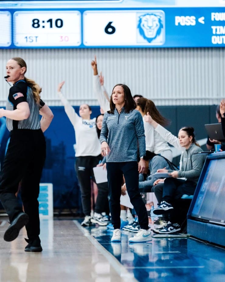 Columbia head coach Megan Griffith stands on the sideline watching the action during a game.