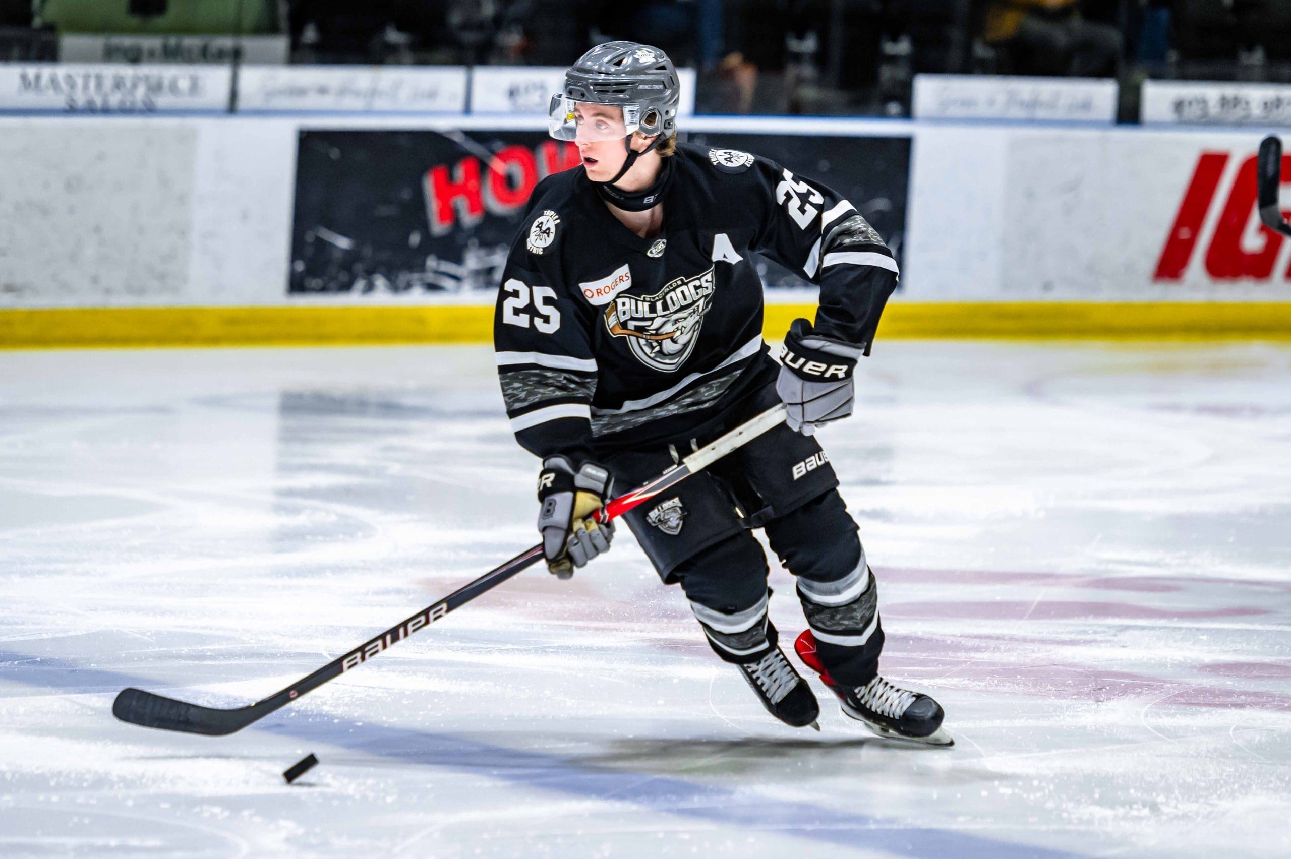 Thomas Neu skating with the puck for the Blackfalds Bulldogs; 02/28/26; Photo Credit: Tom Grimsdale/Ideal Images Red Deer