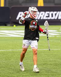Aiden Carroll of the Maryland Whipsnakes celebrates a goal in his black Maryland jersey.
