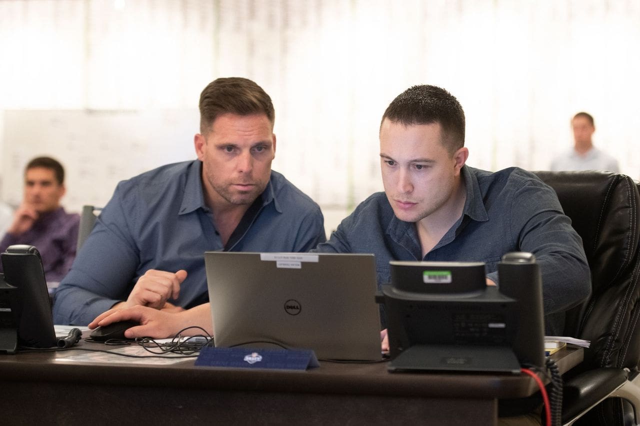 Minnesota Vikings New GM Nolan Teasley. staring at his laptop while at the draft for the Seattle Seahawks of the NFL.
